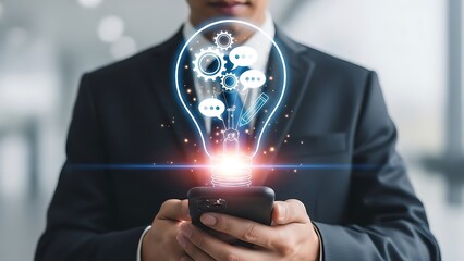 Businessman with Glowing Lightbulb Idea Symbol on Smartphone concept innovation