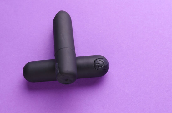 Sex toys. Set of clitoral vibrators on purple background