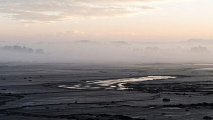 Misty Seascape with Foggy Horizon and Muddy Tidal Flats