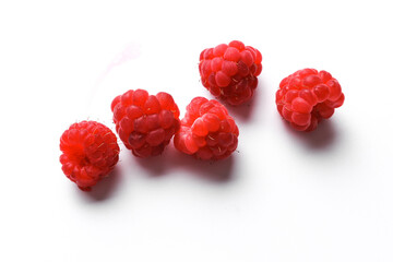 Ripe red raspberries on a white background