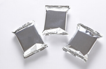 Aluminum or foil packagings for your product, mockup on gray background