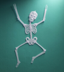 Dancing skeleton on green background