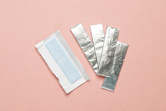 Chewing gum in foil on a pink background