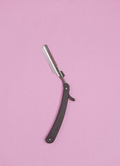 Straight razor on pink background