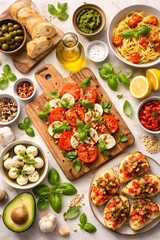 Overhead flat lay of a vibrant Mediterranean food spread featuring caprese salad with tomatoes, mozzarella, and basil, fresh bread, olives, pesto, olive oil, pasta, bruschetta, and herbs on a light.