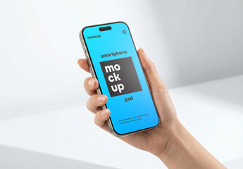 A hand holding a smartphone mockup