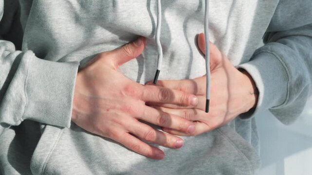 Bloating and digestive problems in a young man.
The man suffers from abdominal cramps.
Food poisoning from stale food.