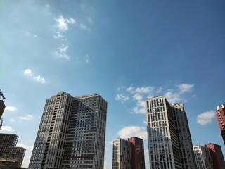 Contemporary buildings captured from below on sky background