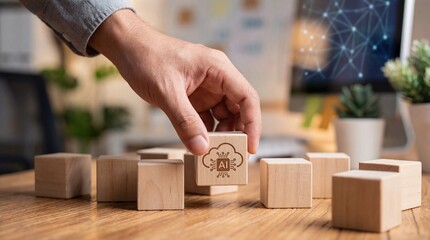 Adult mans hand placing a wooden block with AI and cloud symbol, representing artificial intelligence and cloud computing in business