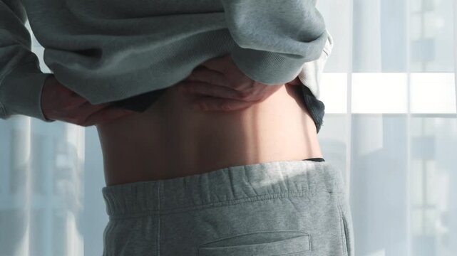 Lower back pain in a man standing in a bright room during the day.
Herniated disc in a man's back.
Treatment for back injuries and recovery from contusions
