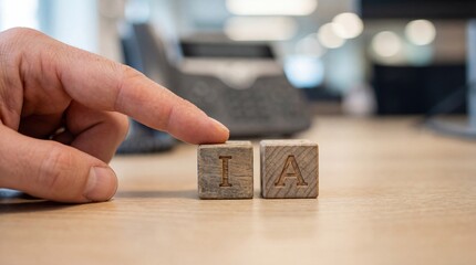 Adult mans finger pointing at wooden blocks with letters I and A on an office desk, representing Artificial Intelligence concept