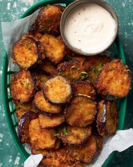 Crispy fried eggplant served with dipping sauce at a casual dining spot on a sunny afternoon