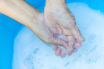 Fototapeta premium Hands Washing with Soap and Foam in Clean Water, Close-up, Wash hands hygiene, sanitation, disease prevention, and sustainable water use for health