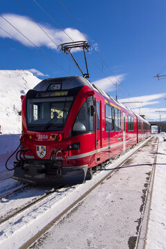 Alp Gr&uuml;m, Switzerland - January 2, 2026: Breathtaking view of the iconic red Bernina Express train winding through the Alps. This image captures the spectacular scenery of the UNESCO World Heritage.