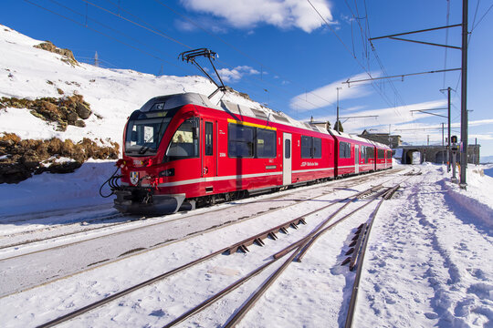 Alp Gr&uuml;m, Switzerland - January 2, 2026: Breathtaking view of the iconic red Bernina Express train winding through the Alps. This image captures the spectacular scenery of the UNESCO World Heritage.