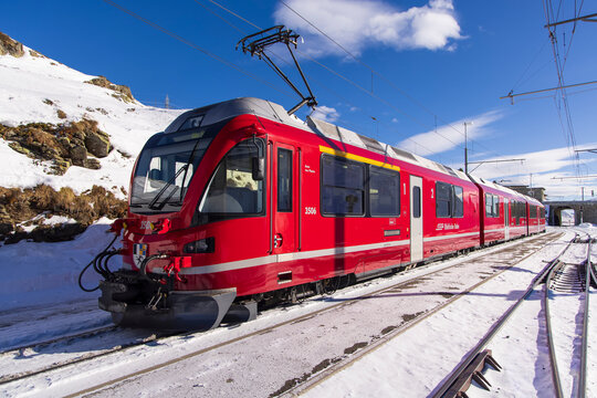 Alp Gr&uuml;m, Switzerland - January 2, 2026: Breathtaking view of the iconic red Bernina Express train winding through the Alps. This image captures the spectacular scenery of the UNESCO World Heritage.