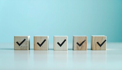 Five wooden blocks arranged in a clean horizontal line on a white surface with a light blue background, each marked with a bold black checkmark&mdash;symbolizing task completion, approval, and goal achievem