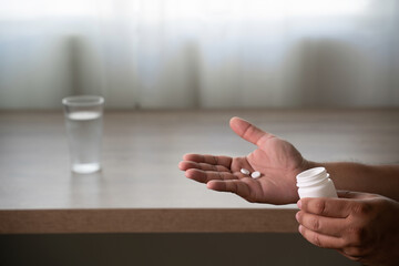 pills medication dosage pouring into hand healthcare concept1
