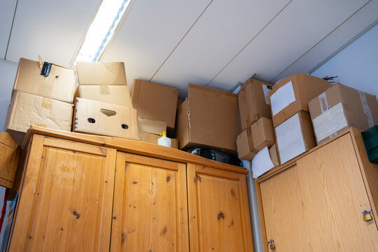 Old archive room with cabinet and stacked cardboard boxes in abandoned office