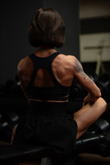 Bodybuilder training in gym while focusing on back muscles and overall strength development during...