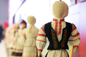 Traditional dolls on display showcase cultural heritage through craftsmanship at a local event in the community center