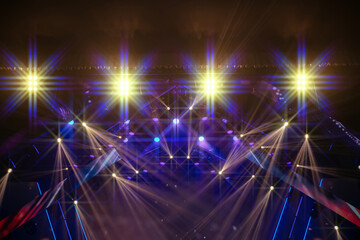 Obraz premium Colorful stage lights illuminate a vibrant music performance in an indoor venue during a live concert event