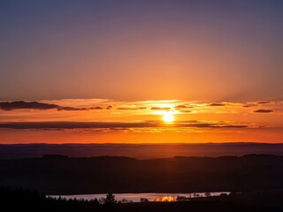Vibrant sunset over rolling hills