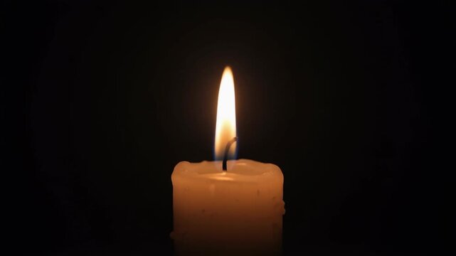 Single Candle Flame Flickering Slowly in Deep Darkness Creating a Respectful and Solemn Meditative Cinematic Atmosphere
