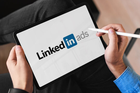 Person using tablet with linkedin ads logo