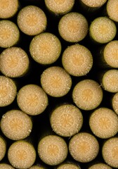 Freshly cut sugarcane stalks stacked closely together, revealing the fibrous, sweet interior used for sugar production and juice ,organic ,farming ,natural