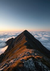 Glorious morning sunlight illuminates a rocky mountain summit towering above a sea of white clouds, symbolizing clear achievement ,ray ,journey ,day