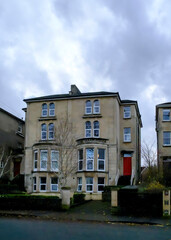 A view of a building with a red door.