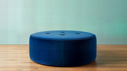 Blue velvet ottoman resting on wooden floor in minimalist room