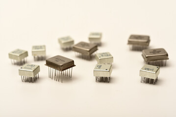 Old chips on a white background. Different electronic chips. Microcircuits in a metal case.
