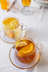 glass cup of tea with lemon on table