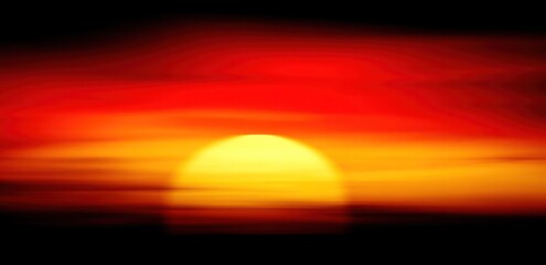 Dramatic sunset with warm colors and a bright sun in a horizontal composition
