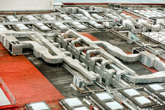Air conditioning pipes and ducts on the roof of a building