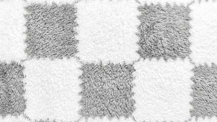 soft fluffy checkerboard texture closeup in gray white alternating squares evoking cozy minimalist vibe for home decor wallpaper or abstract design background
