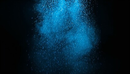 Abstract cloud of bright blue falling powder suspended in darkness