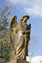 Weathered Stone Angel Statue in Historic Cemetery