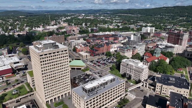 Binghamton, NY downtown city skyline with office buildings, historic architecture, public parks and river flowing through town on Summer sunny warm day
