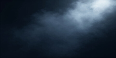 A dark blue smoke texture swirls against a dark background like a stormy night sky filled with clouds of mist and motion © MDNUR