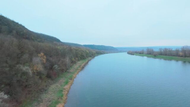 FPV drone Aerial shot flying. Beautiful  view of nature landscape of the Dniester River and forest in late autumn. Moldova, Europe.