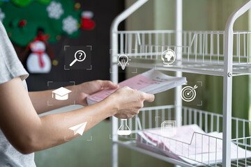 Rural education concept, female teacher holding student worksheets develop learning skills, simple classroom background in countryside school, development, teaching ideas, learning improvement