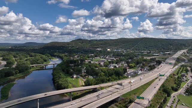 Driving on interstate highway in Binghamton City in New York State beside peaceful river in summer