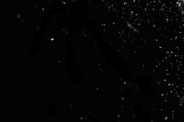 Snow particles overlay on black background. High quality photo
