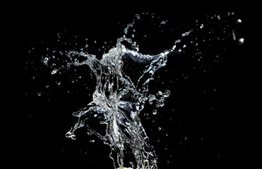 Captivating water splash, frozen in time, displaying dynamic movement and elegance against a dark background.