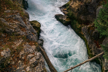 Mountain stream rushing through rocky canyon