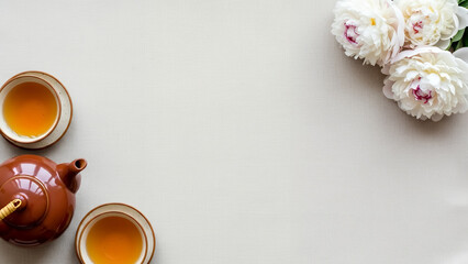 Soft tea themed Qingming festival background with neutral copyspace background and peony flowers. Elegant spring design background with space for text