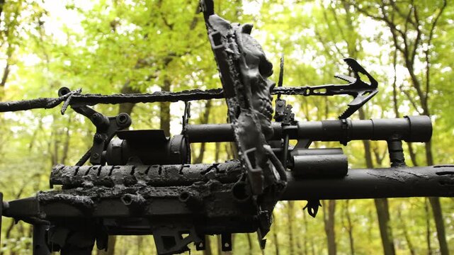 Rugged metal, post-apocalyptic theme, war-ready. Rugged, weaponized metal structure with pointed details sits in dense forest, exuding dystopian atmosphere.